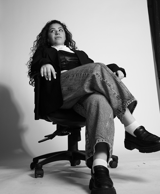 Black and white portrait, seated in an office chair