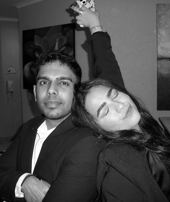 Black and white photo of a couple embracing playfully